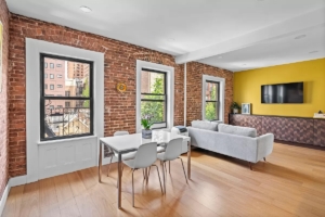 living room with exposed brick in Upper West Side 2-bedroom