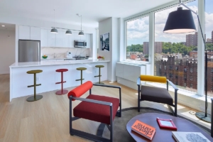 colorful chairs and huge windows in living room and kitchen in Fort George - Manhattan 2-bedroom rentals