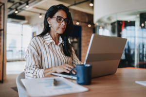 woman on laptop in an office - private listing networks