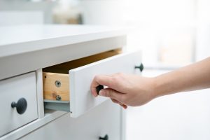 photo of a person pulling a cabinet drawer