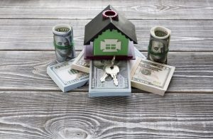 photo of a money and a model home and keys