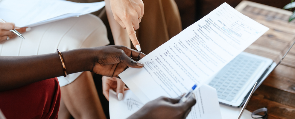 Real estate agent and clients reviewing a co-op board application