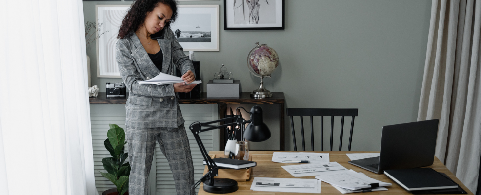 Real estate agent on phone looking over paperwork