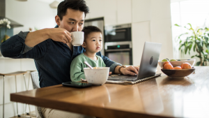 Father working from home with young son