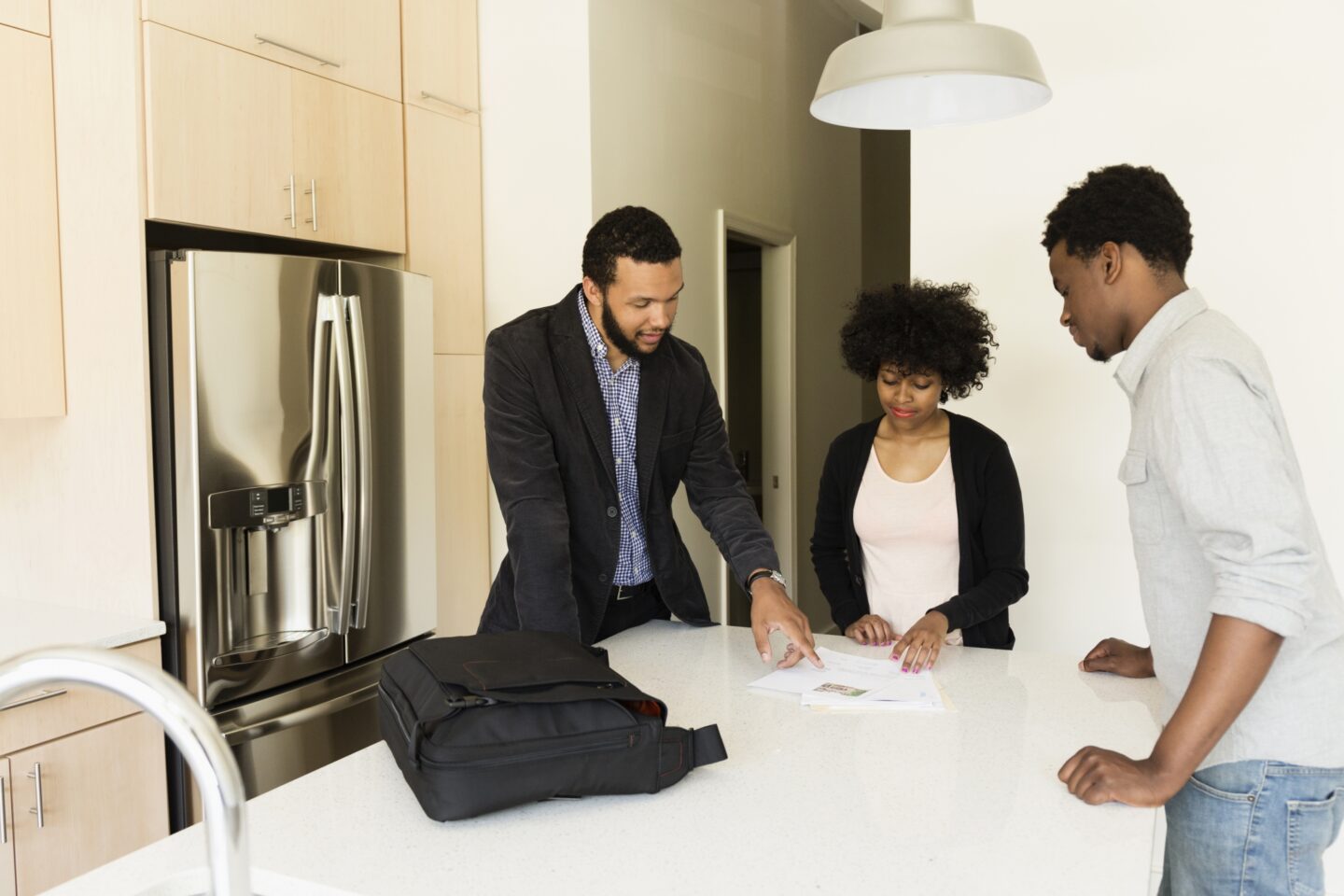 Real estate agent showing seller disclosures to two buyers